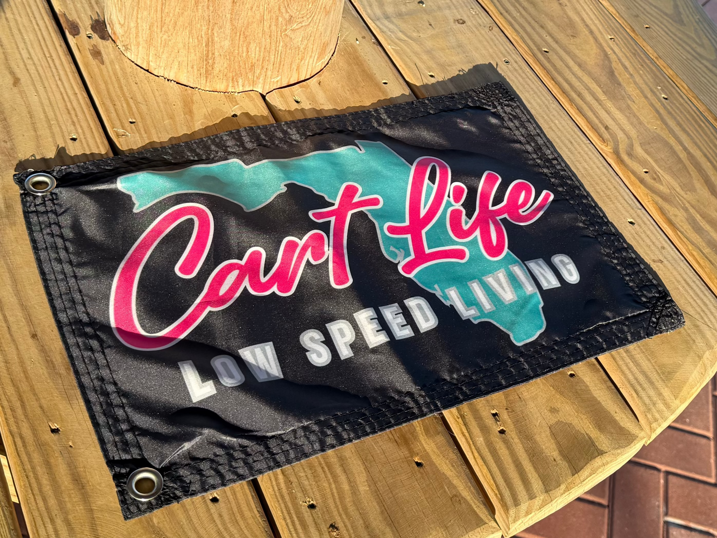 Wooden post with a 'Can't Life' sign on a patio
